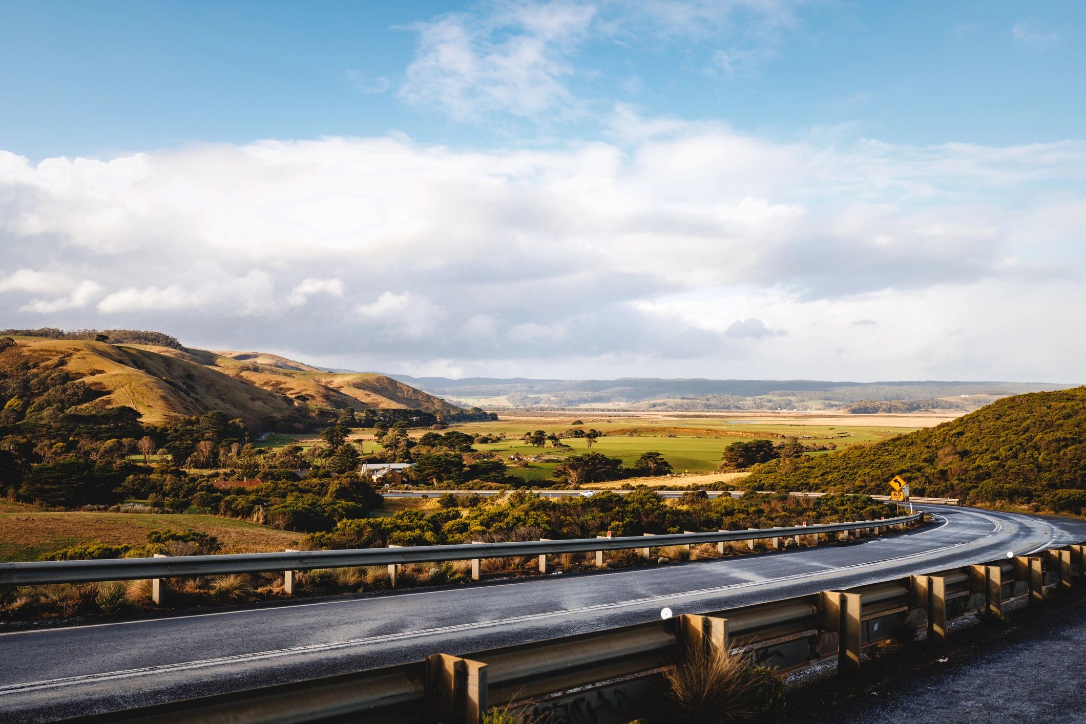 Winding road through green hills for scenic touring